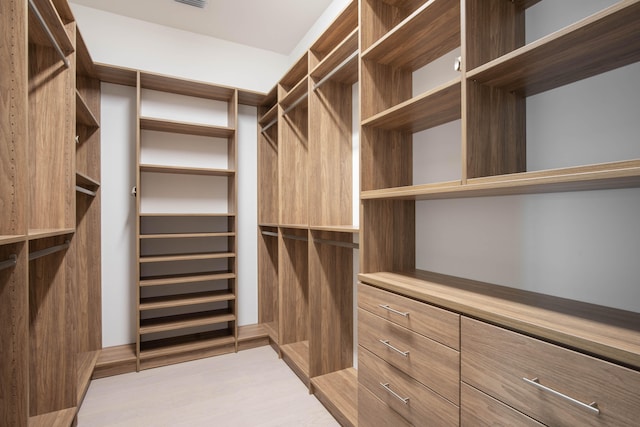 walk in closet featuring light hardwood / wood-style floors