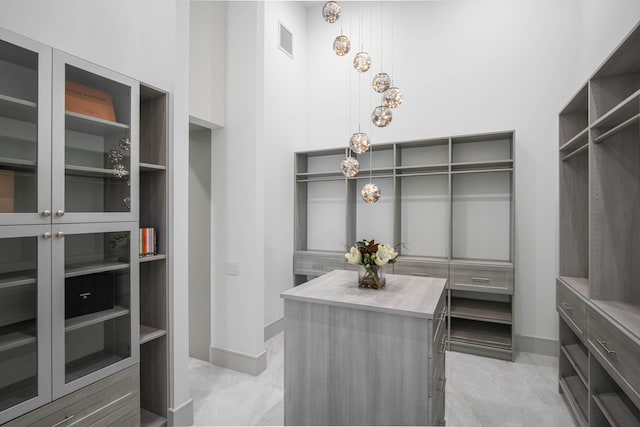 walk in closet with light tile patterned flooring