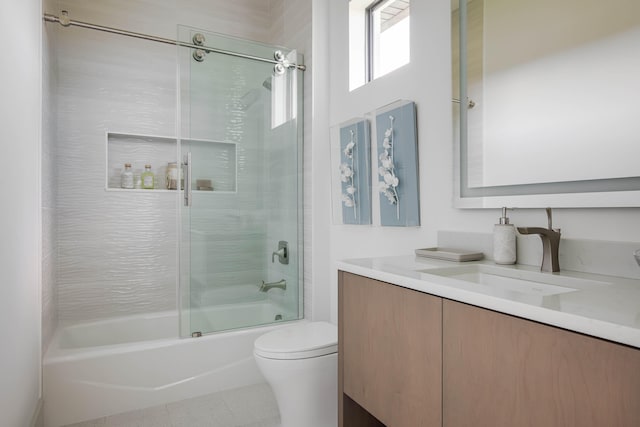 full bathroom with tile patterned flooring, combined bath / shower with glass door, toilet, and vanity