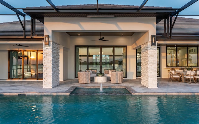 view of pool featuring a patio, ceiling fan, and a lanai