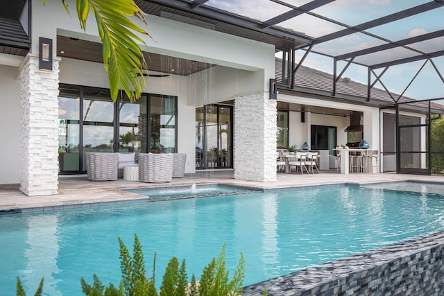 view of pool with a patio area, ceiling fan, and glass enclosure