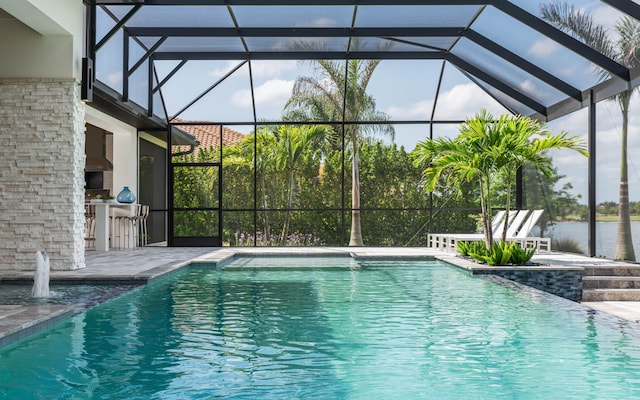 view of swimming pool featuring a patio area and glass enclosure