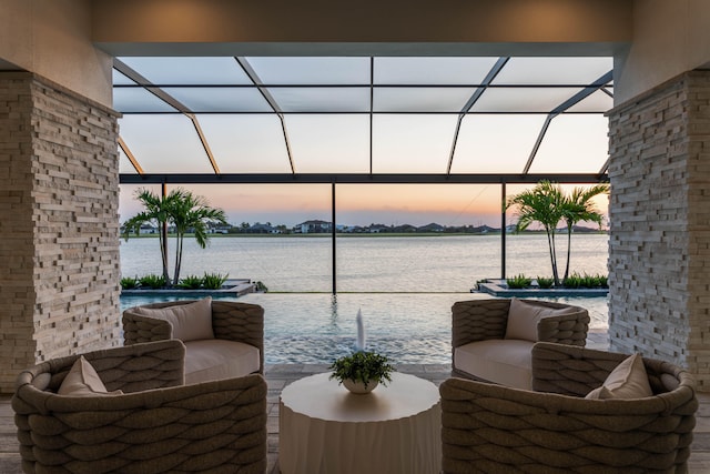 patio terrace at dusk featuring a water view