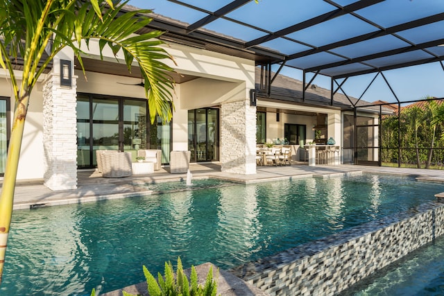 view of swimming pool with glass enclosure and a patio area