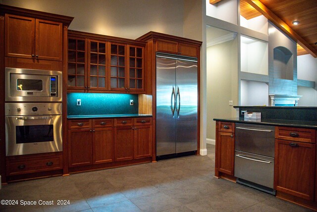 kitchen featuring wooden ceiling, built in appliances, high vaulted ceiling, beam ceiling, and tasteful backsplash