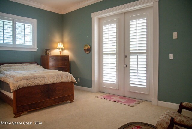 carpeted bedroom featuring ornamental molding and french doors