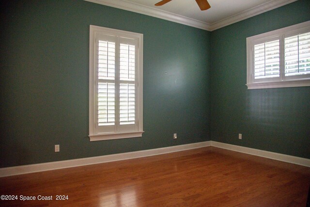 unfurnished room featuring crown molding, wood-type flooring, and ceiling fan