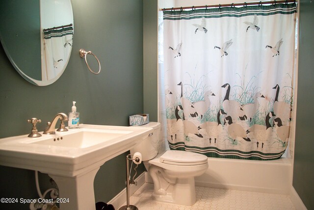 bathroom featuring toilet, tile patterned floors, and shower / bathtub combination with curtain