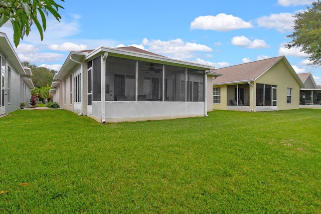 back of property featuring a yard and a sunroom