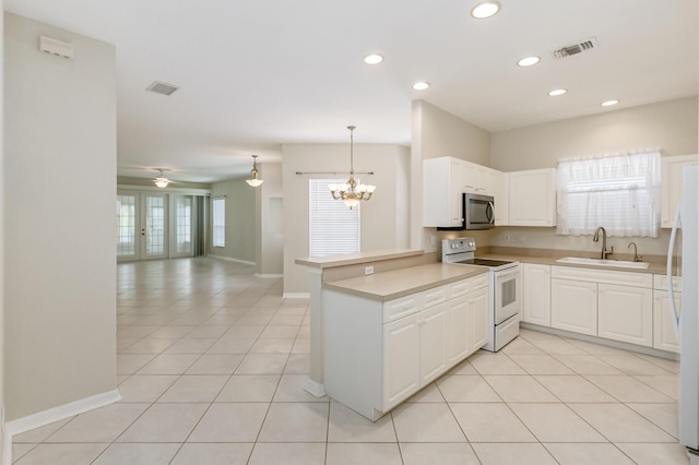 kitchen featuring white electric stove, visible vents, stainless steel microwave, open floor plan, and a sink