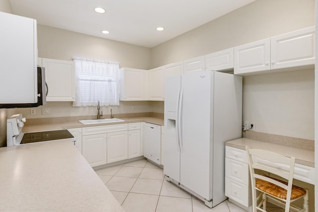 kitchen with light tile patterned floors, recessed lighting, white appliances, a sink, and light countertops