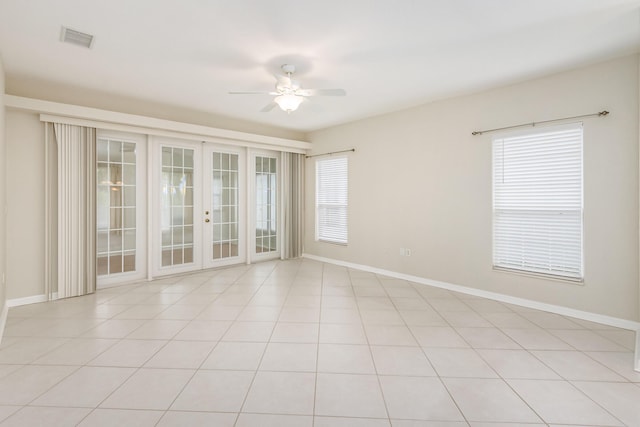 spare room featuring french doors, visible vents, ceiling fan, and baseboards