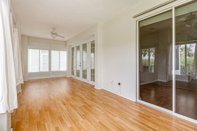 unfurnished sunroom featuring ceiling fan