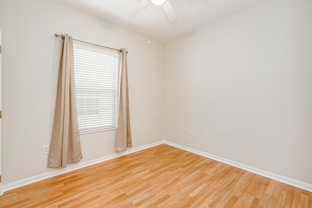 unfurnished room with a ceiling fan, baseboards, and wood finished floors