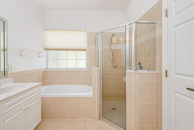 bathroom with a stall shower, a garden tub, vanity, and tile patterned floors