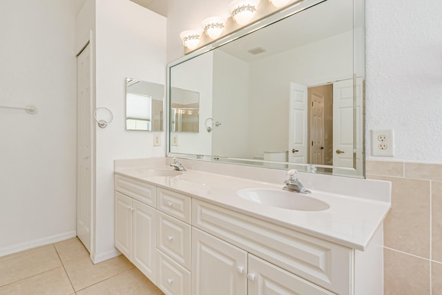 bathroom with double vanity, a sink, and tile patterned floors