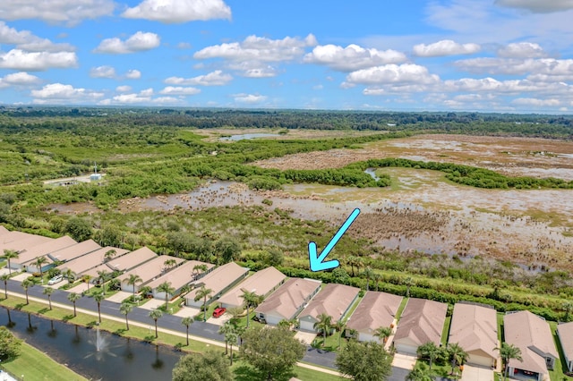 drone / aerial view with a water view and a residential view