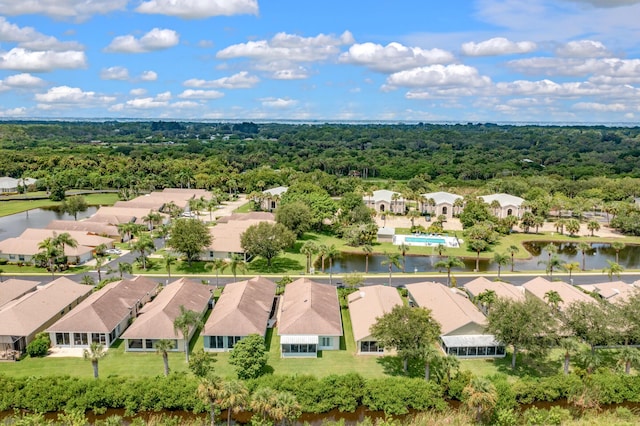 aerial view with a residential view, a water view, and a wooded view