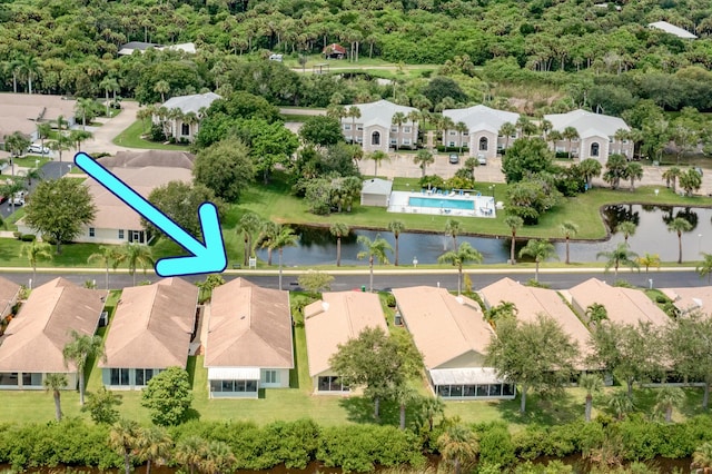 drone / aerial view featuring a water view and a residential view