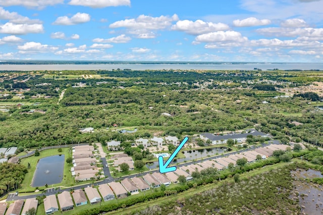 drone / aerial view with a water view and a residential view