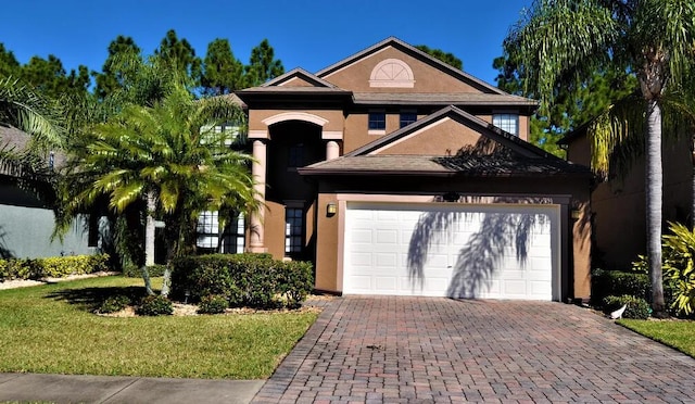 view of front of home with a garage and a front lawn