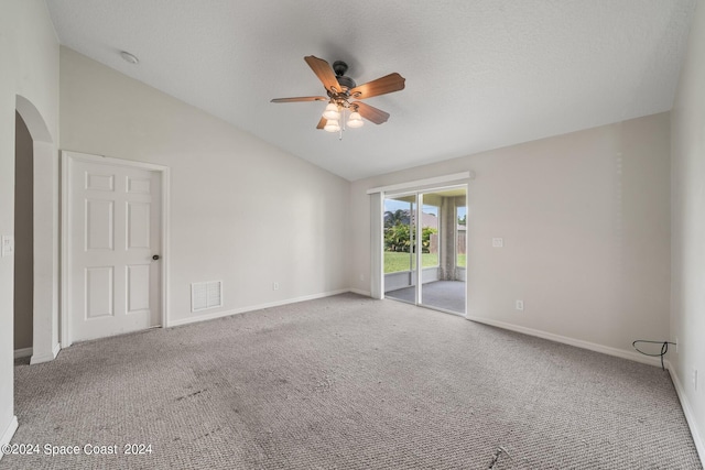 carpeted spare room featuring high vaulted ceiling and ceiling fan