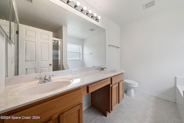 full bathroom with a textured ceiling, vanity, shower with separate bathtub, toilet, and tile patterned floors