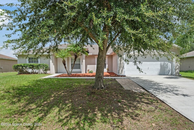 view of front of home with a front yard and a garage