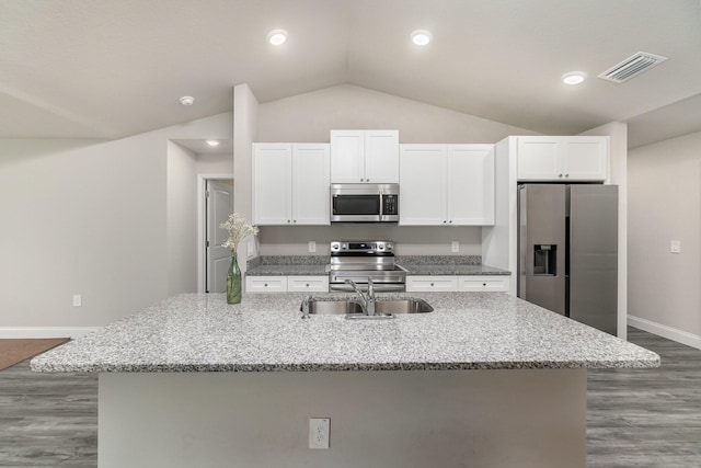 kitchen with appliances with stainless steel finishes, a kitchen island with sink, and white cabinets