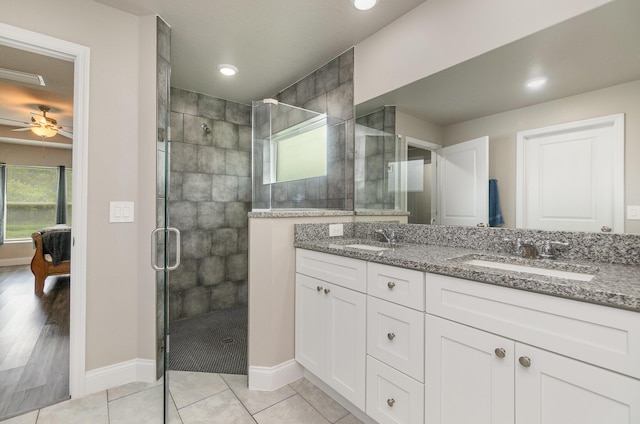 bathroom featuring walk in shower, ceiling fan, tile patterned floors, and vanity