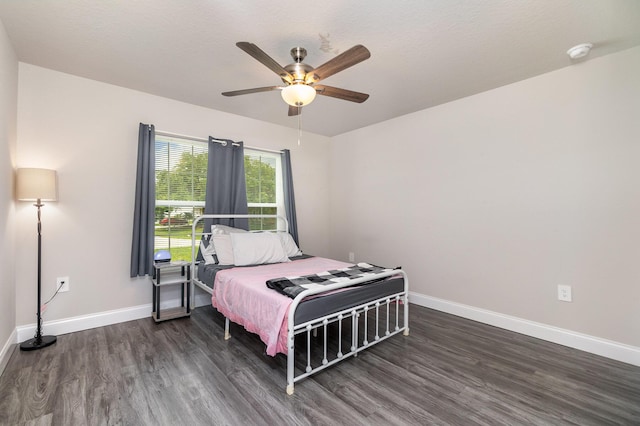 bedroom with ceiling fan and dark hardwood / wood-style floors