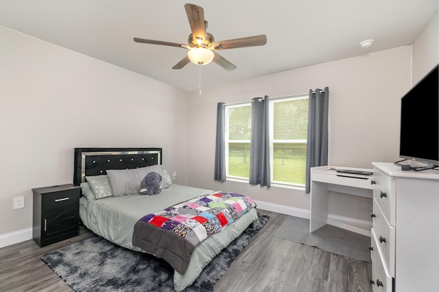 bedroom with dark hardwood / wood-style floors and ceiling fan