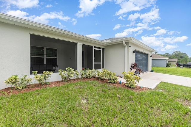 exterior space featuring a garage and a lawn