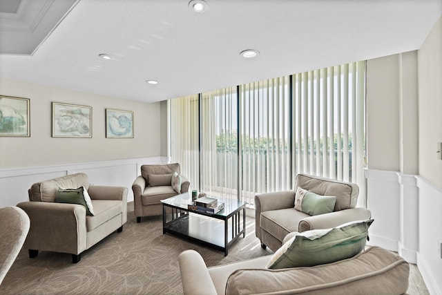 living room featuring a wall of windows, a wealth of natural light, a wainscoted wall, and recessed lighting