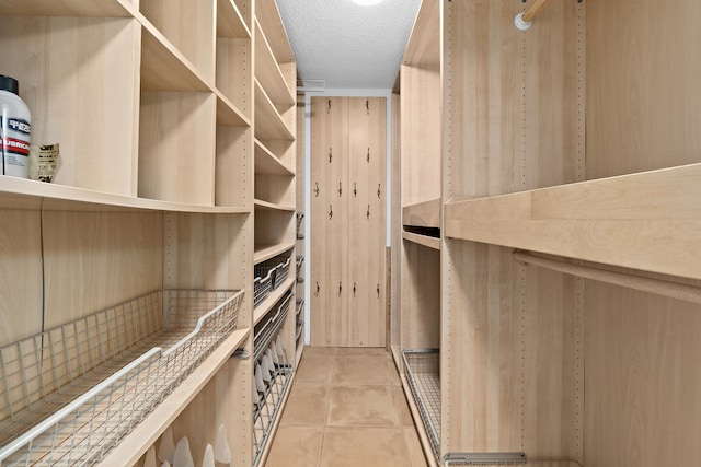 spacious closet with light tile patterned floors