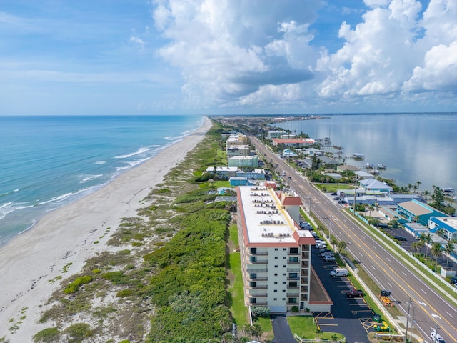 drone / aerial view with a water view and a view of the beach