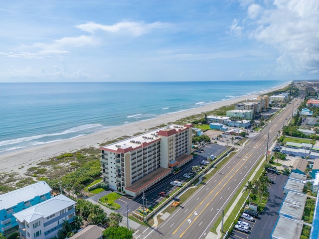 drone / aerial view with a water view and a view of the beach