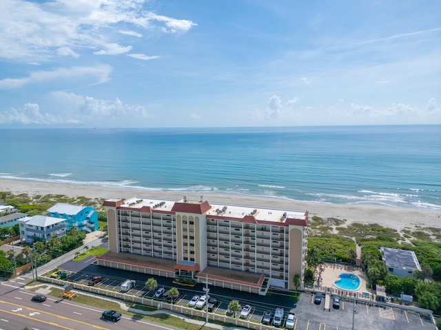 birds eye view of property featuring a water view and a beach view