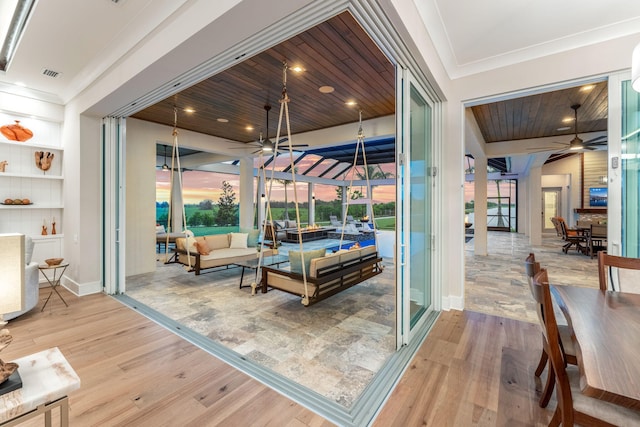 living room featuring ceiling fan, light wood-type flooring, wooden ceiling, and built in features