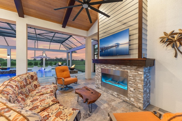 living room featuring wood ceiling, high vaulted ceiling, beamed ceiling, ceiling fan, and an outdoor stone fireplace