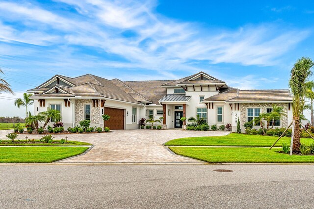 view of front of property with a front yard and a garage