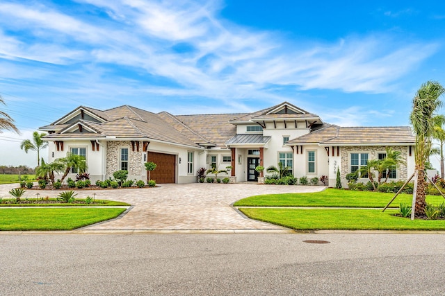 view of front of house featuring a garage and a front yard