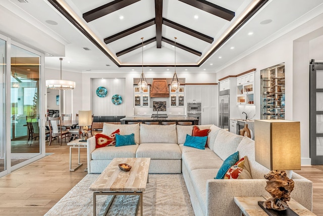 living room with high vaulted ceiling, light wood-type flooring, crown molding, and an inviting chandelier