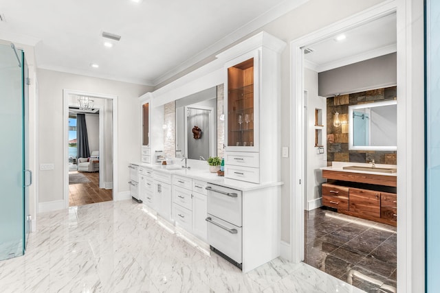 bathroom featuring tile patterned floors, tile walls, double vanity, and crown molding