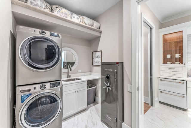 washroom with stacked washing maching and dryer, sink, beverage cooler, cabinets, and crown molding