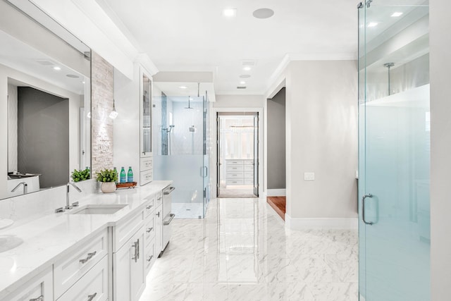 bathroom featuring a shower with shower door, double vanity, ornamental molding, and tile patterned floors