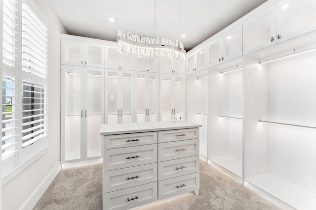 spacious closet featuring light colored carpet