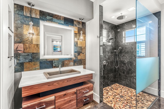 bathroom featuring vanity, tile walls, a tile shower, and tile patterned flooring