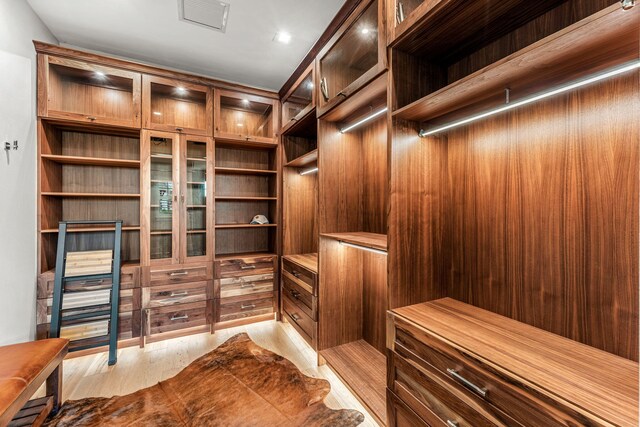 walk in closet featuring light hardwood / wood-style floors