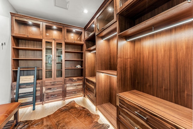 walk in closet featuring light hardwood / wood-style flooring